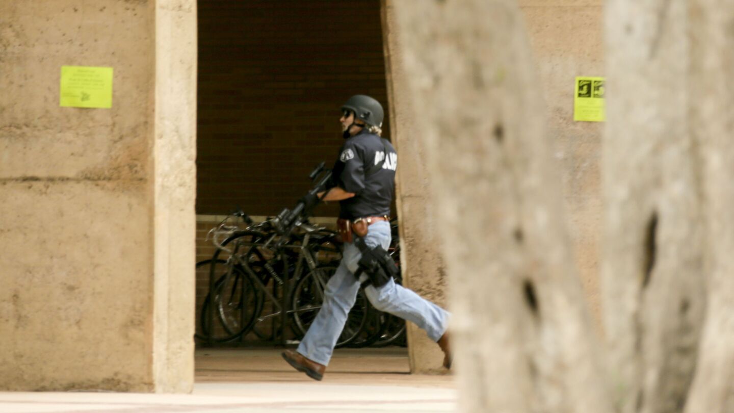 A police officer searches the UCLA campus after a shooting on Wednesday.