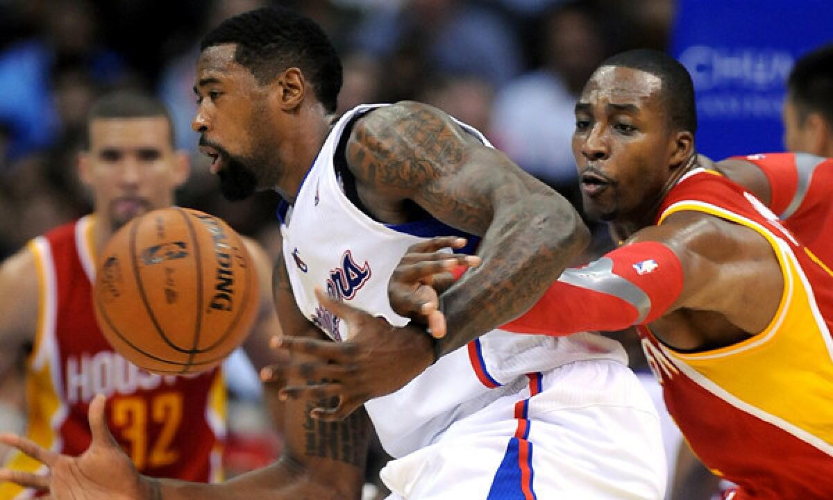 Houston Rockets power forward Dwight Howard, right, knocks the ball away from Clippers center DeAndre Jordan during a game on Nov. 4. Howard has played a big role in the Rockets' resurgence this season.
