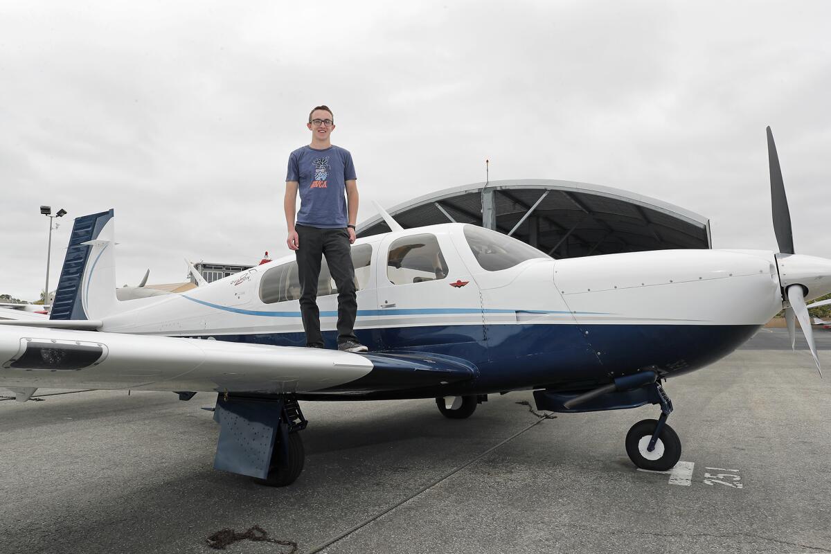 Asher Green on the wing of his single-engine plane.