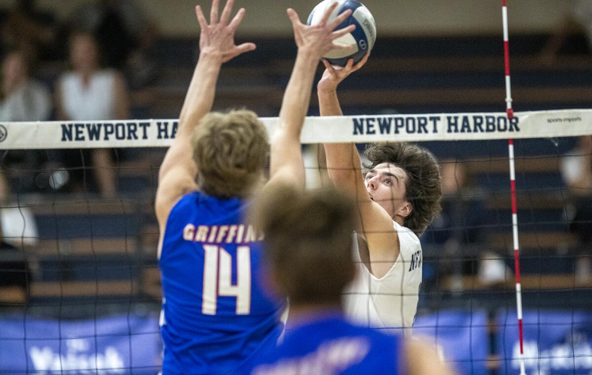 Newport Harbor's Jake Read goes up for a ball at the net against Los Alamitos' Nate Baddeley on Tuesday.