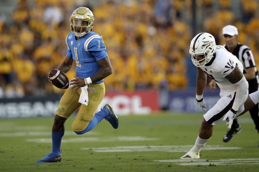 UCLA quarterback Dorian Thompson-Robinson scrambles during the first half of a game against Arizona State on Oct. 26.