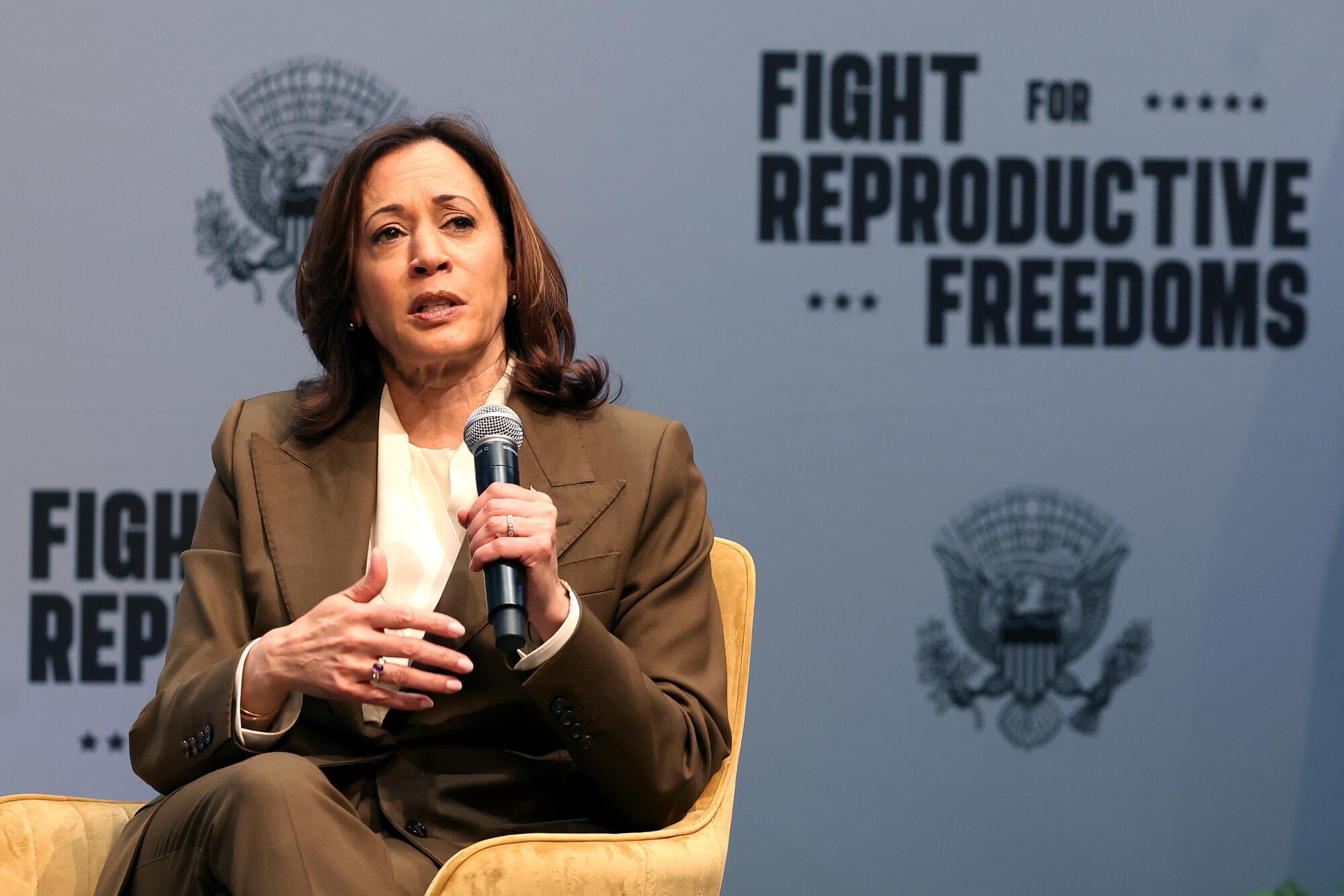 Vice President Kamala Harris holding a microphone 