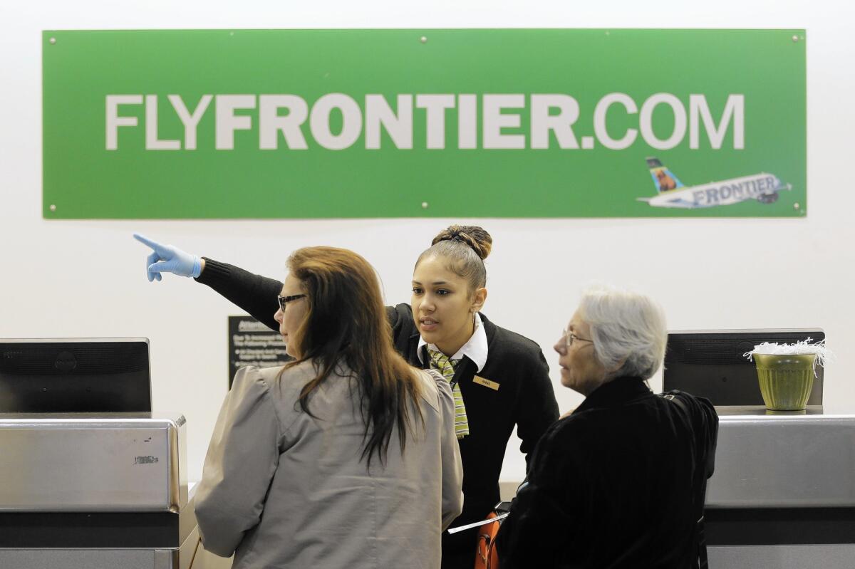 A Frontier Airlines worker wears rubber gloves at Cleveland Hopkins International Airport. A nurse who has been diagnosed with Ebola took a Frontier flight from Cleveland to Dallas.