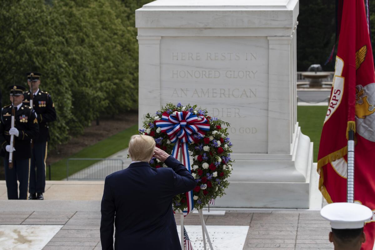 President Trump salutes after placing a wreath at the Tomb of the Unknown Soldier in Arlington National Cemetery to mark Memorial Day on May 25, 2020, in Virginia.