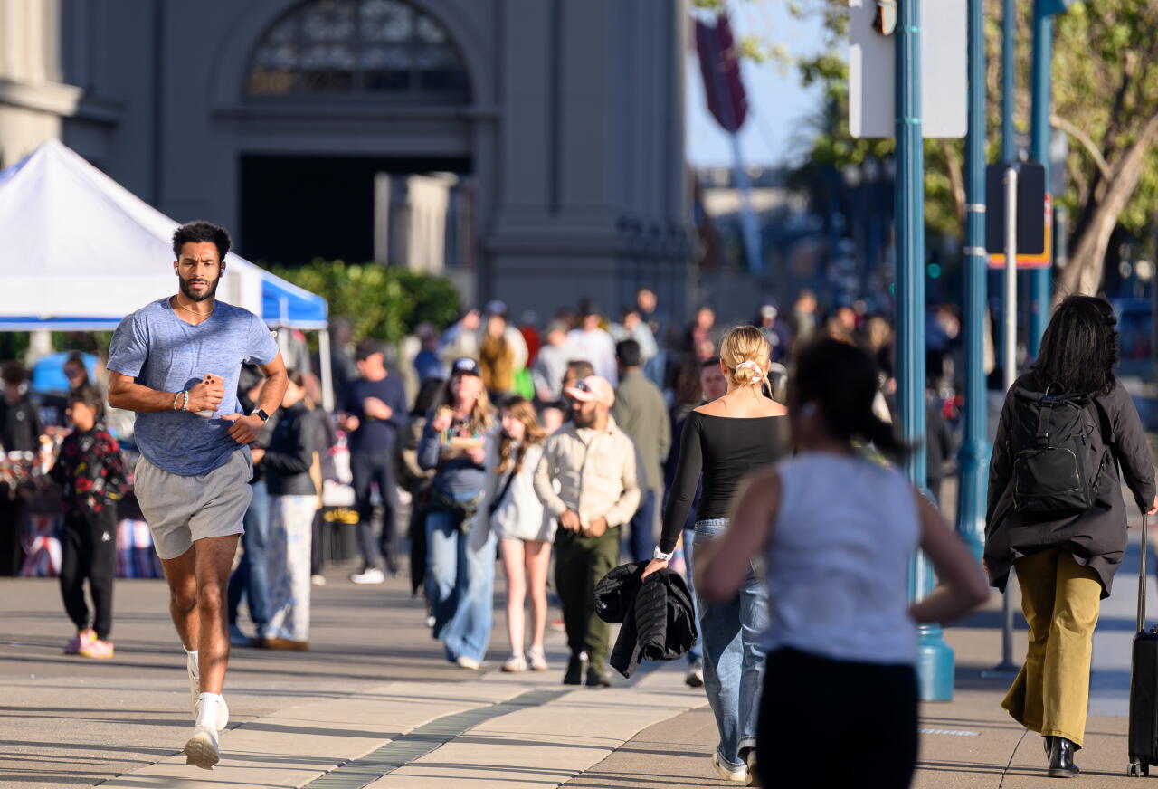 A man jogs near the Ferry Building in San Francisco