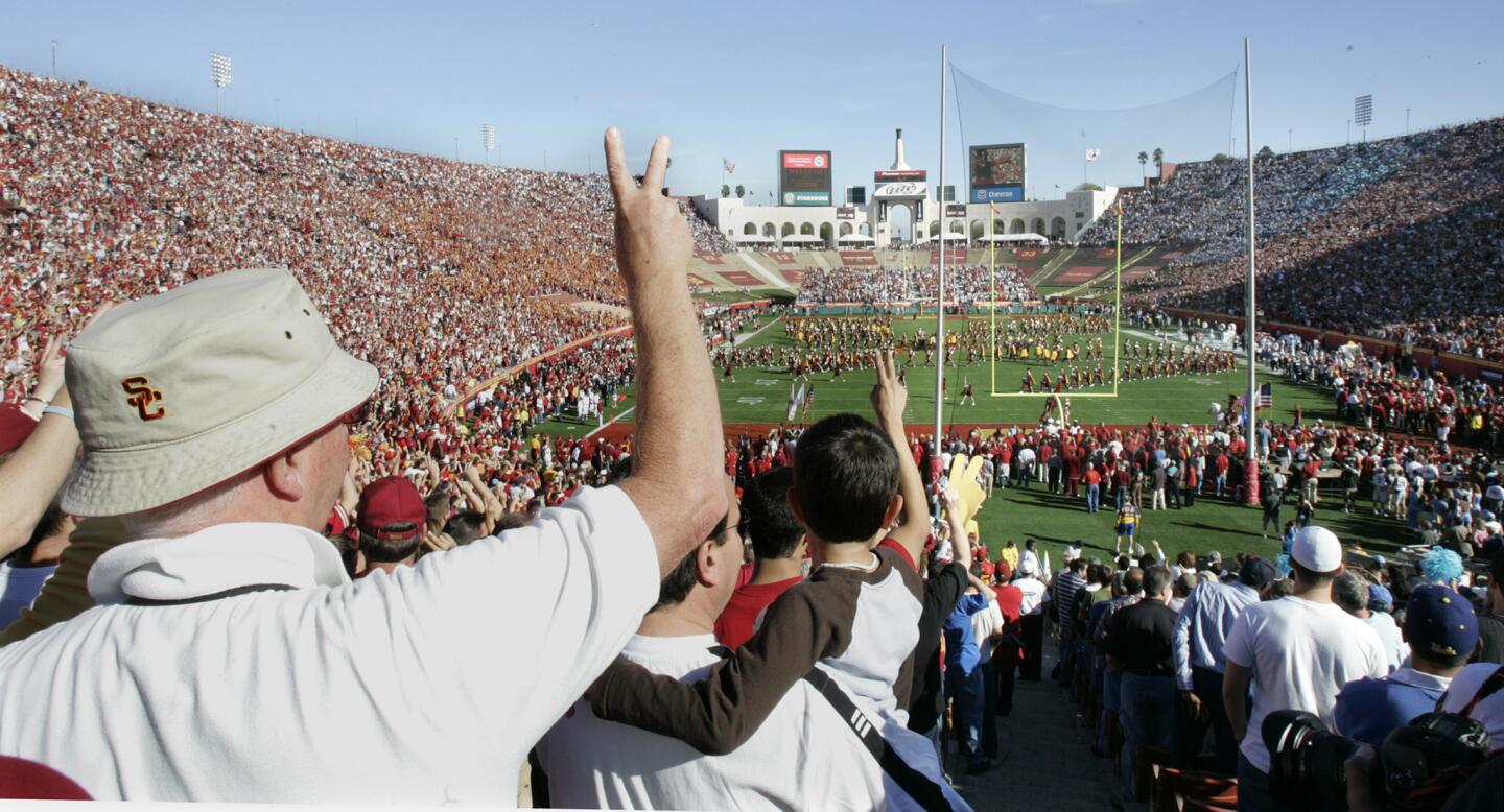 USC fans cheer before a game against UCLA at the Coliseum on Dec. 3, 2005.