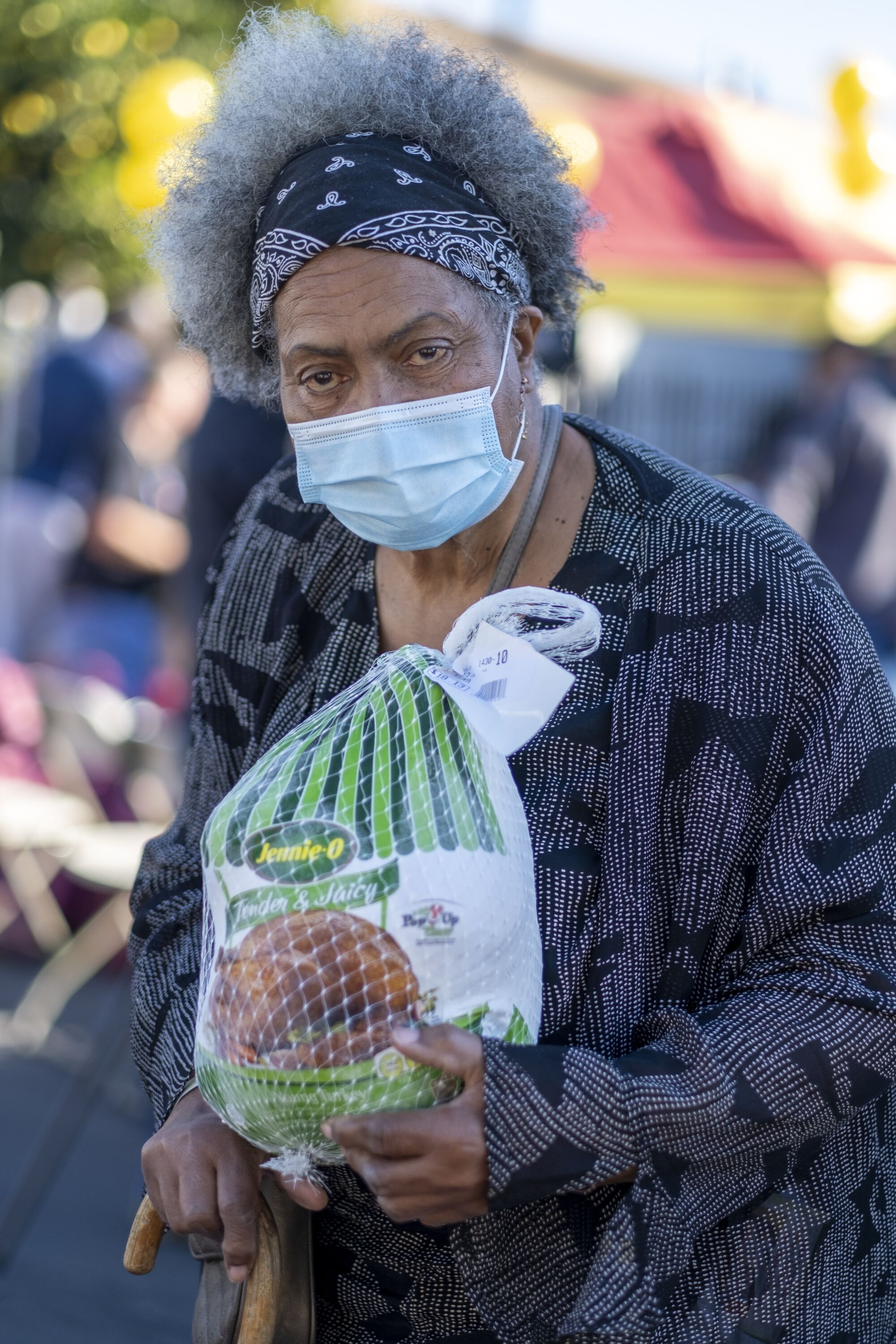 A woman holds a turkey.