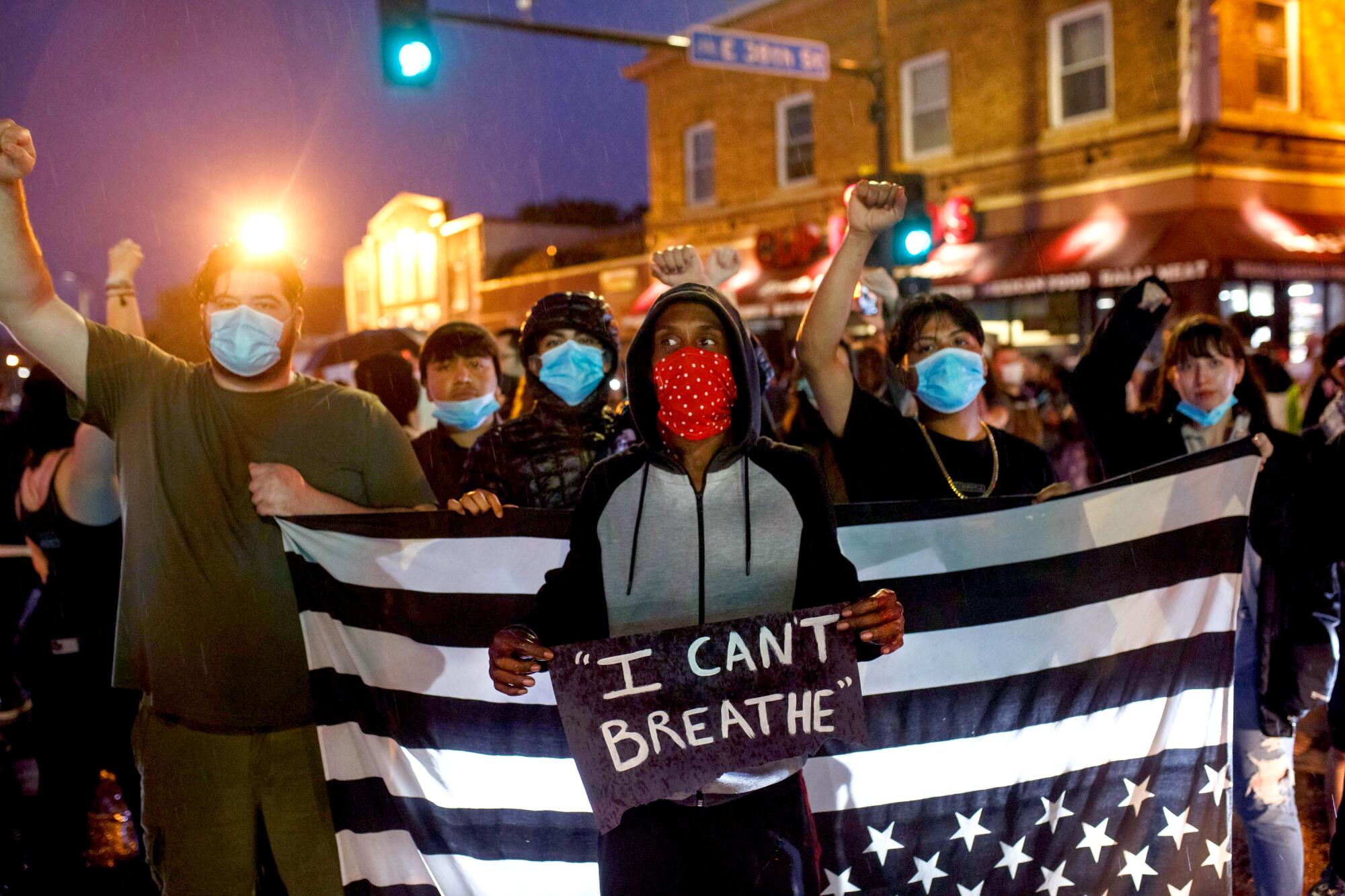 Protesters gather near the place where George Floyd died in custody in Minneapolis.