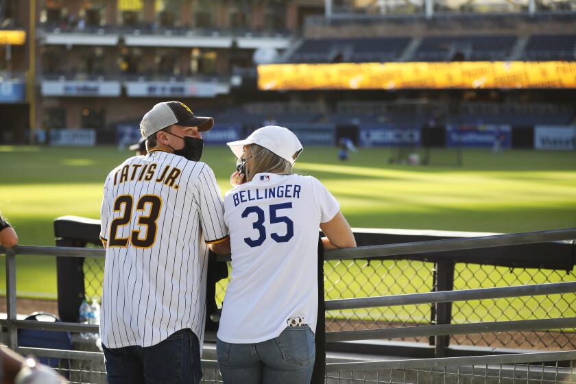 SAN DIEGO, CA - APRIL 16: Ethan Cloutier, and his girlfriend Caelan Gianni watch batting practice.
