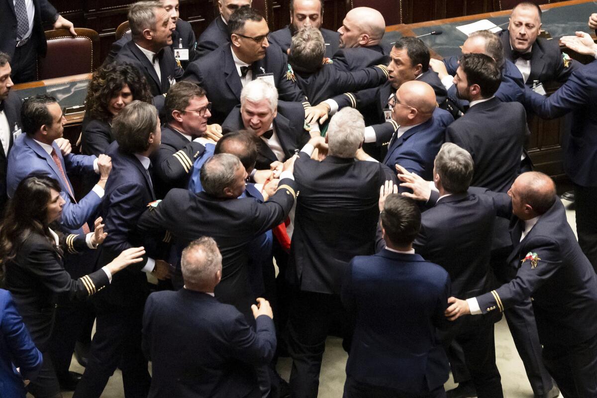 Lawmakers scuffle on the floor of the Italian Parliament