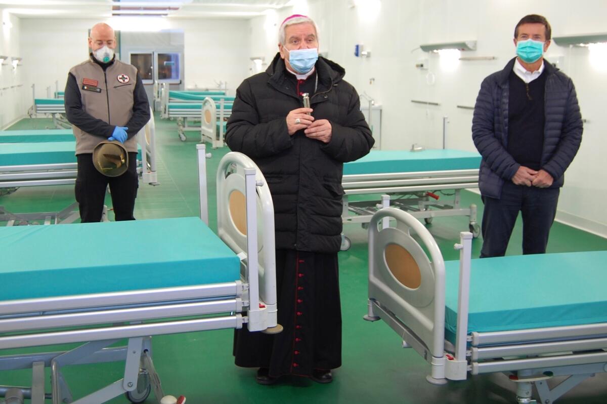 Bergamo, Italy, Bishop Francesco Beschi, center, performs a benediction while project director Sergio Rizzini, left, and Bergamo Mayor Giorgio Gori, right, listen.