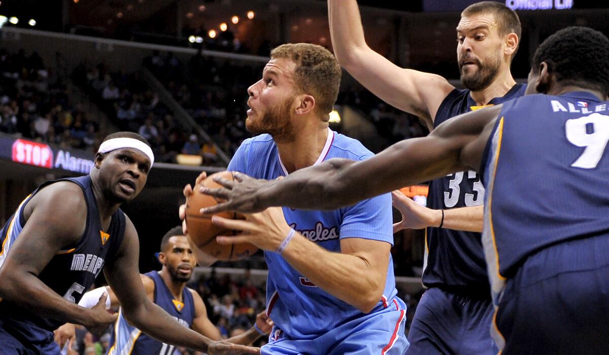 Clippers power forward Blake Griffin is surrounded by Grizzlies defenders as he looks to score in the first half Sunday.