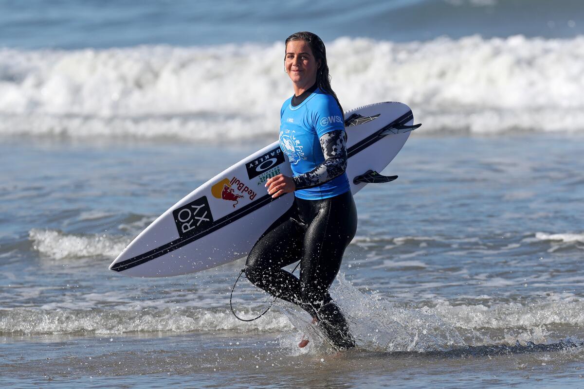 San Clemente resident Caroline Marks walks out of the water Saturday after winning her U.S. Open quarterfinal heat.