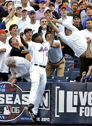 GAME 1: A fan interferes as New York Mets first baseman Carlos Delgado tries to catch a foul ball hit by Dodgers Nomar Garciaparra in the second inning.