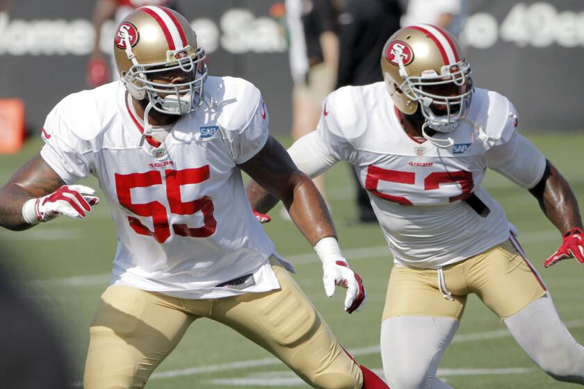 San Francisco 49ers outside linebacker Ahmad Brooks, left, and NaVorro Bowman line up during a training camp practice on Aug. 18.