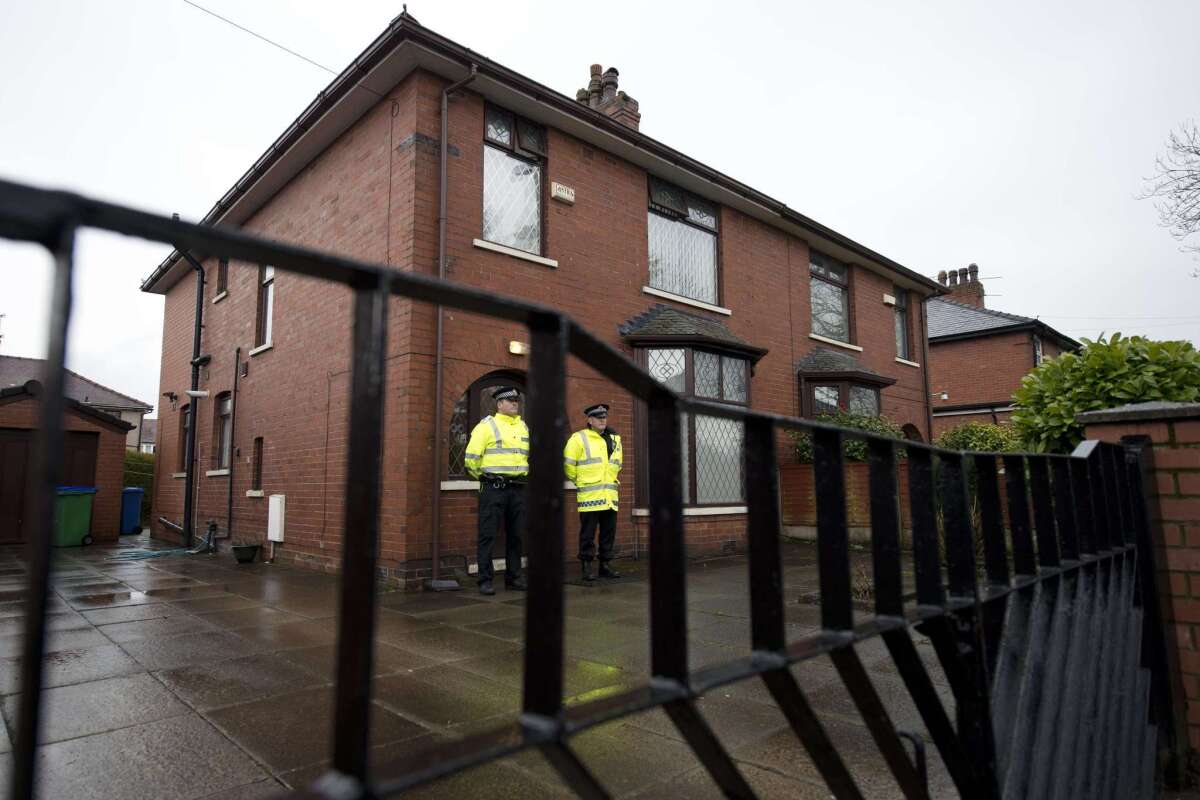 Police officers stand guard in Rochdale, northern England, on April 3 outside the family home of one of nine British citizens currently detained by Turkish authorities for allegedly attempting to illegally enter Syria from Turkey.