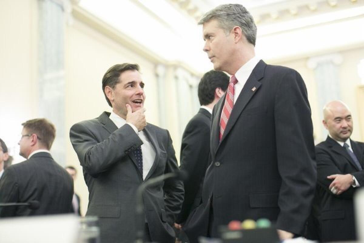 Federal Communications Commission Chairman Julius Genachowski, left, and FCC Commissioner Robert McDowell arrive to testify before the Senate Commerce Committee on March 12.