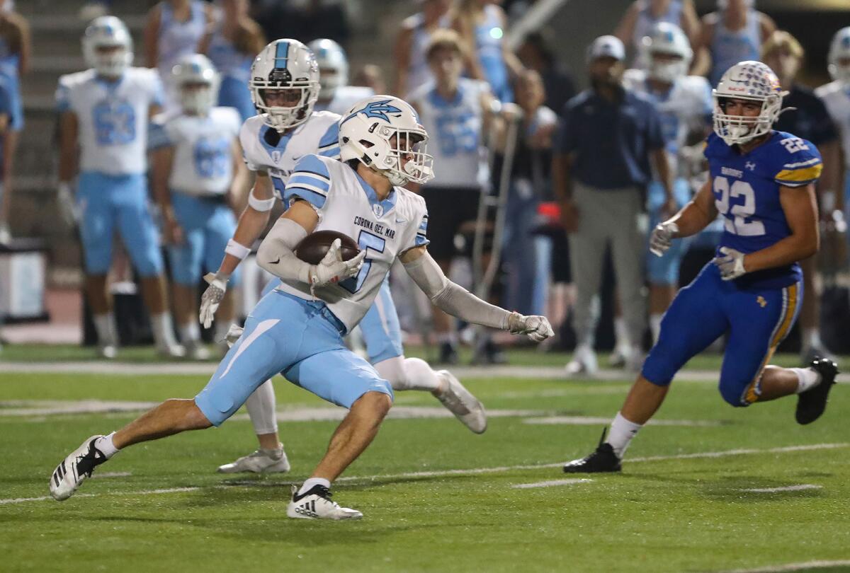 Corona del Mar's Oliver Ayala (5) finds a gap and runs for a touchdown on a punt return against Fountain Valley on Thursday.