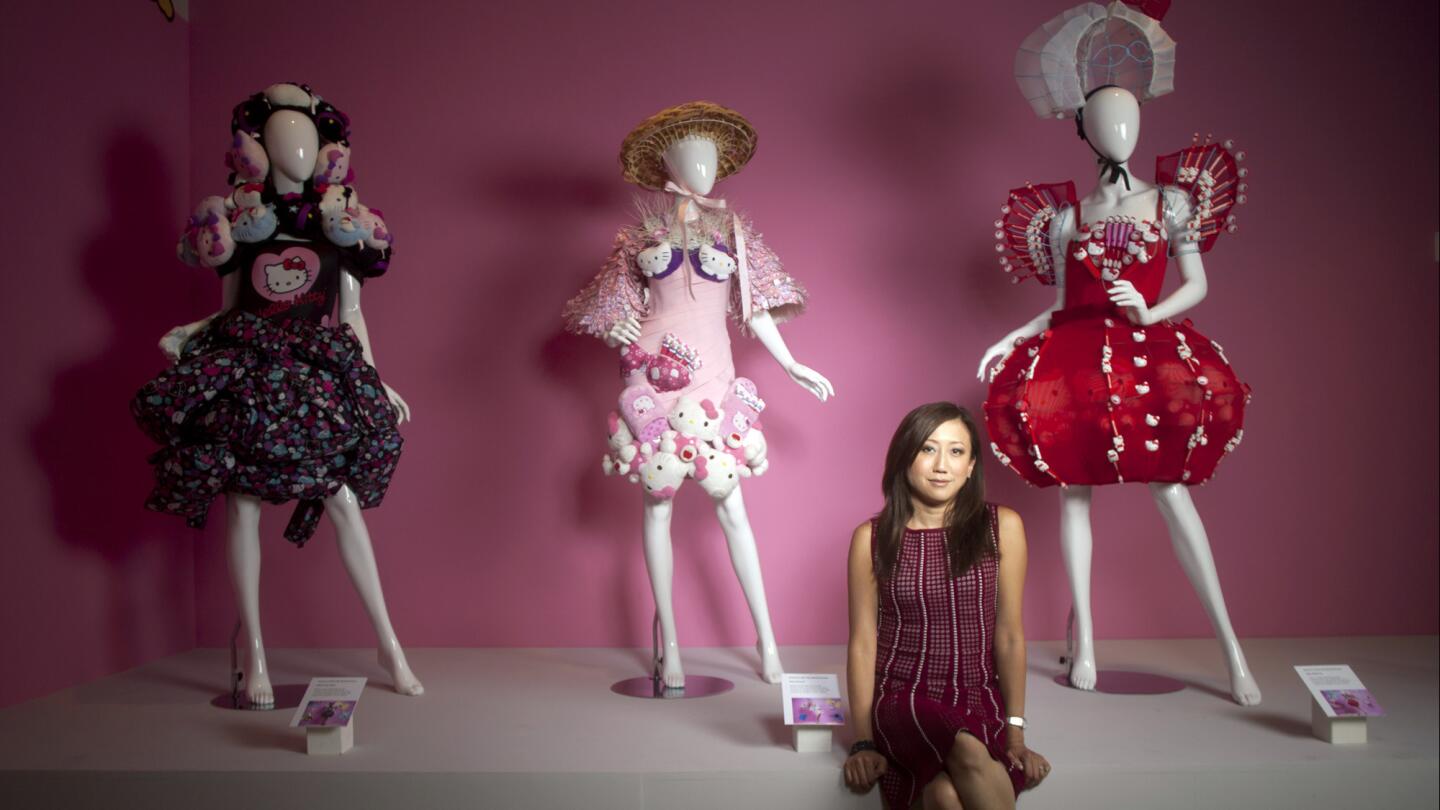 Janet Hsu, president of Sanrio Inc., sits in front of Hello Kitty dress creations at the Japanese American National Museum in Little Tokyo this month.