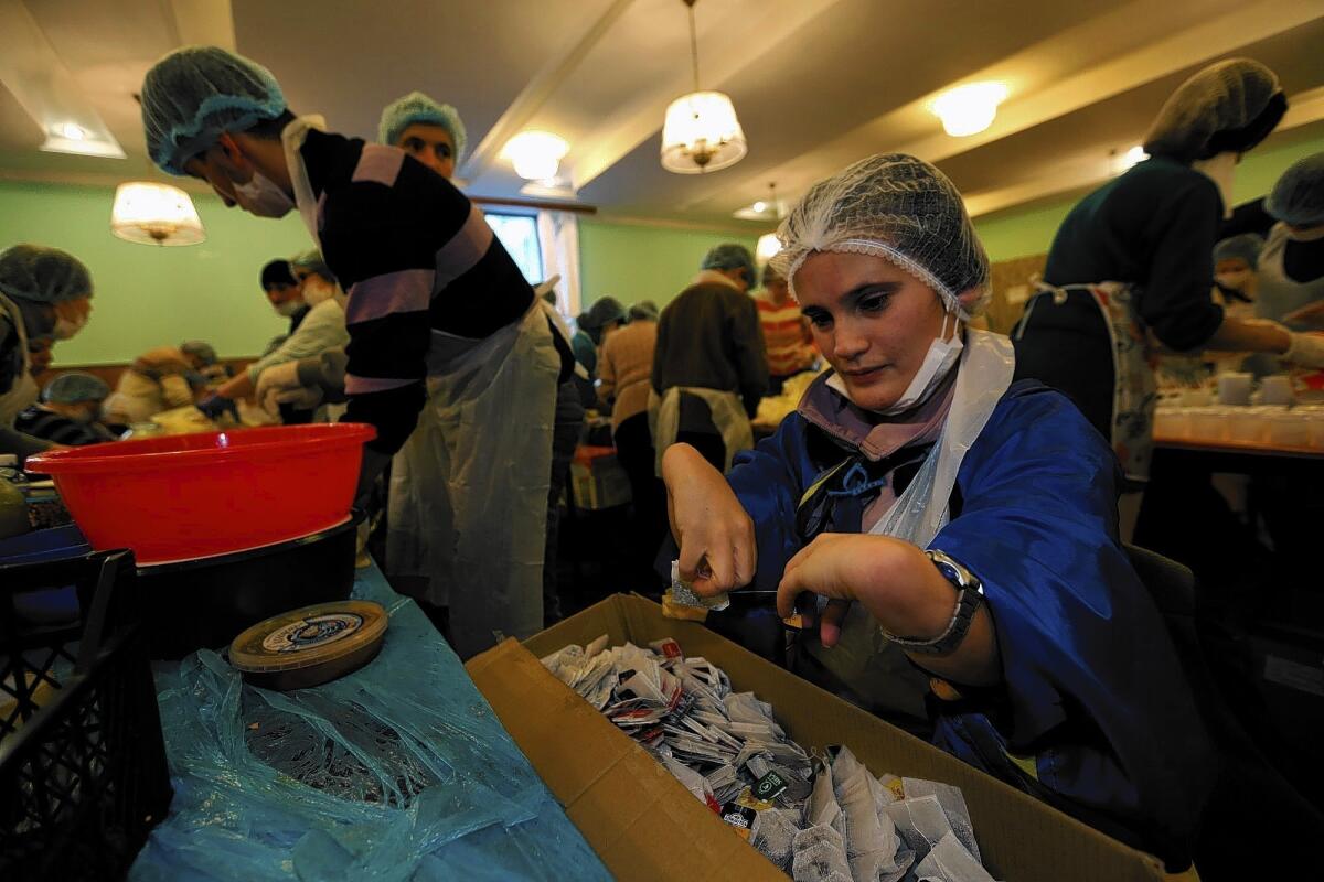 Liza Shaposhnik, who has cerebral palsy, works in the kitchen of the opposition-occupied Trade Unions building in Kiev. Shaposhnik, who initially traveled to the capital from the Donetsk region in search of work, says she feels "reborn" by her daily efforts aiding the opposition cause.