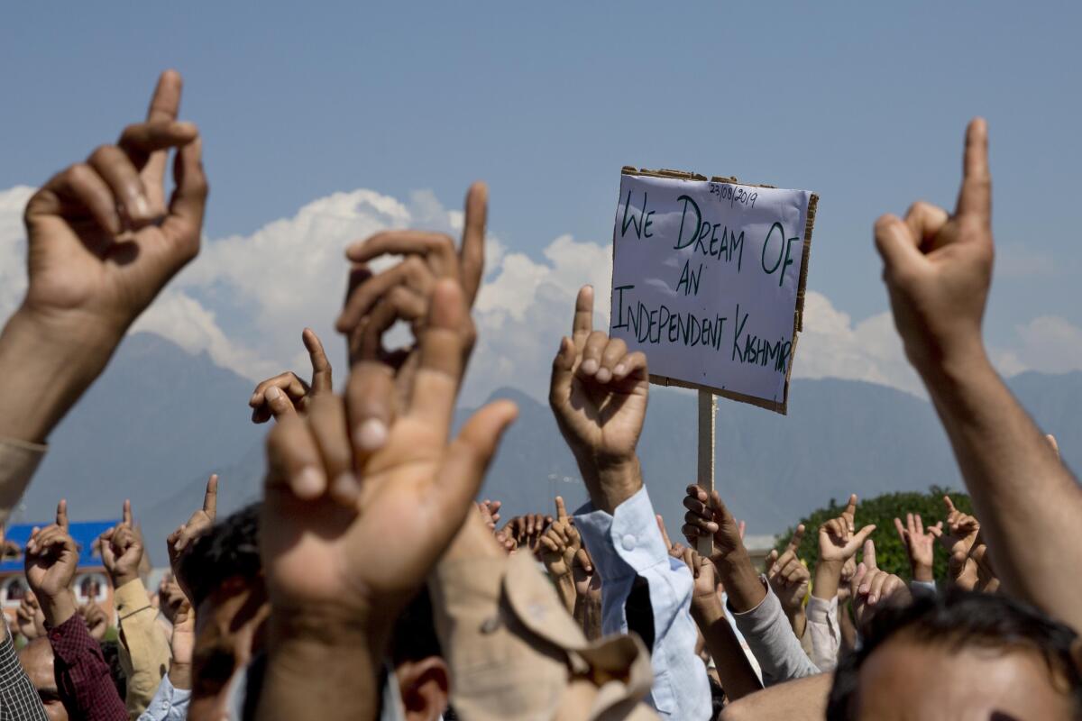FILE - In this Friday, Aug. 23, 2019, file photo, Kashmiris shout freedom slogans during a protest against New Delhi's tightened grip on the disputed region, after Friday prayers on the outskirts of Srinagar, Indian controlled Kashmir. The death of top separatist leader Syed Ali Geelani on Sept. 1, 2021, in disputed Kashmir and the ensuing crackdown on public movement and communications by Indian authorities have highlighted the turmoil seething just below the surface in the region. Soon after the 92-year-old's death late Wednesday, authorities quickly clamped down, blocking internet and mobile phone services and restricting public movement out of fear of anti-India protests. (AP Photo/ Dar Yasin, File)