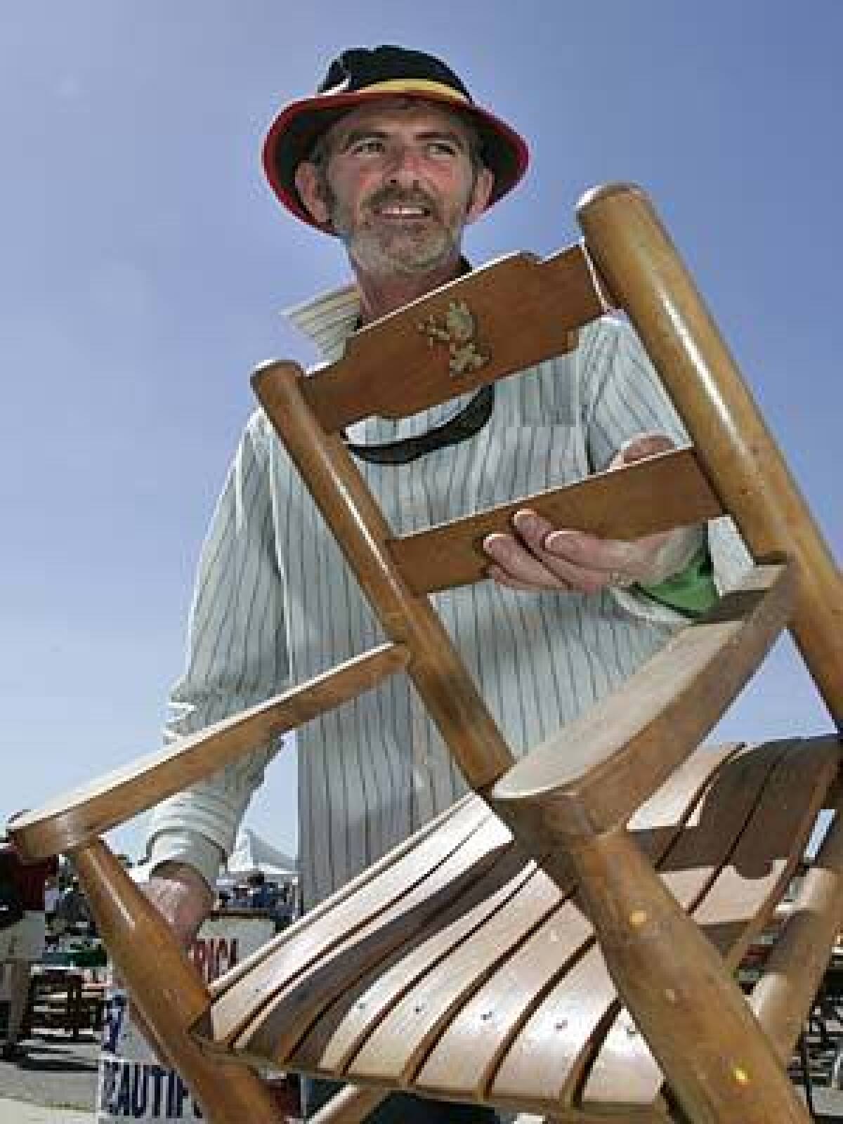 Niall Bourke walks through the Ventura Flea Market checking for quality woodwork and craftsmanship. He pronounces a child's rocker a steal at $35.