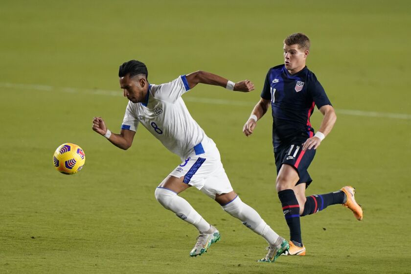 El Salvador midfielder Denis Pineda (8) and U.S forward Chris Mueller (11) battle for the ball, Wednesday, Dec. 9, 2020, during the first half of an international friendly match in Fort Lauderdale, Fla. (AP Photo/Wilfredo Lee)