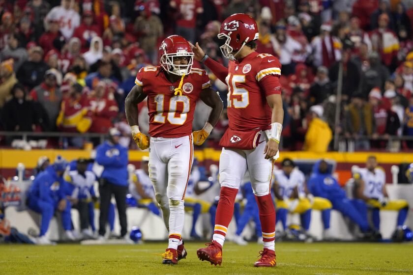 Kansas City Chiefs running back Isiah Pacheco (10) talks with teammate quarterback Patrick Mahomes (15) during the second half of an NFL football game against the Los Angeles Rams Sunday, Nov. 27, 2022, in Kansas City, Mo. (AP Photo/Ed Zurga)