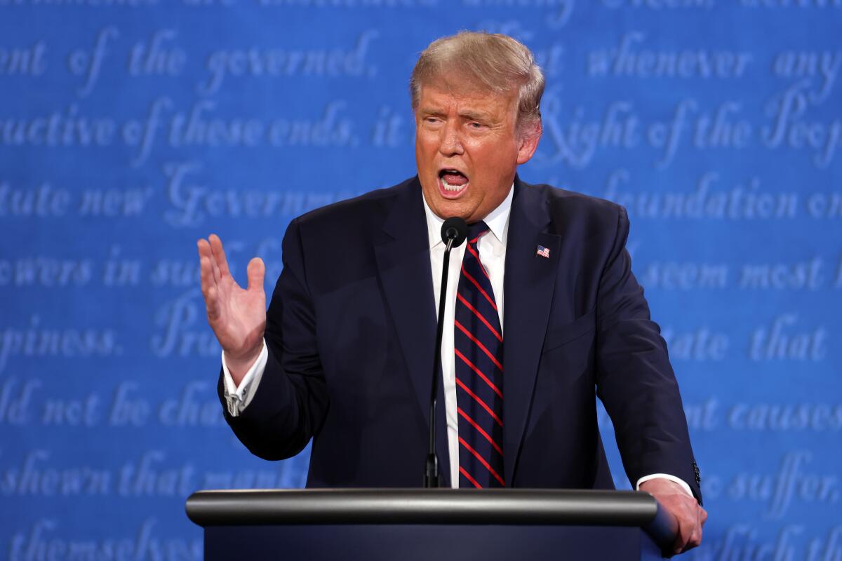 President Trump speaking at a lectern and gesturing