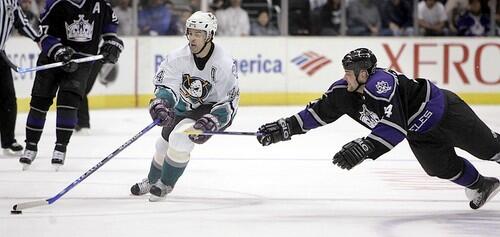 Kings' Mattias Norstrom makes a dive for Mighty Ducks' Rob Niedermayer and the puck.