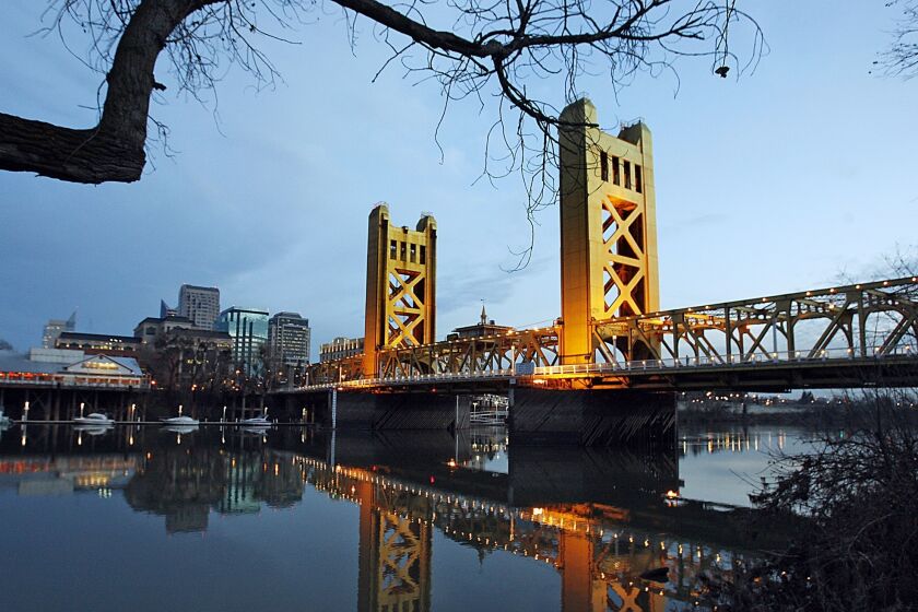 Downtown Sacramento rises from the banks of the Sacramento River near the historic Tower Bridge.