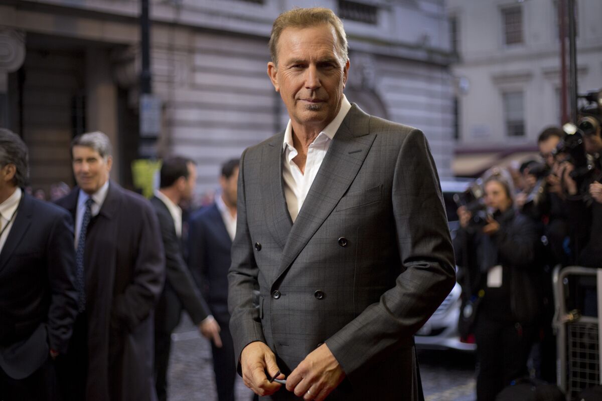 A man with short blond hair in a grey suit
