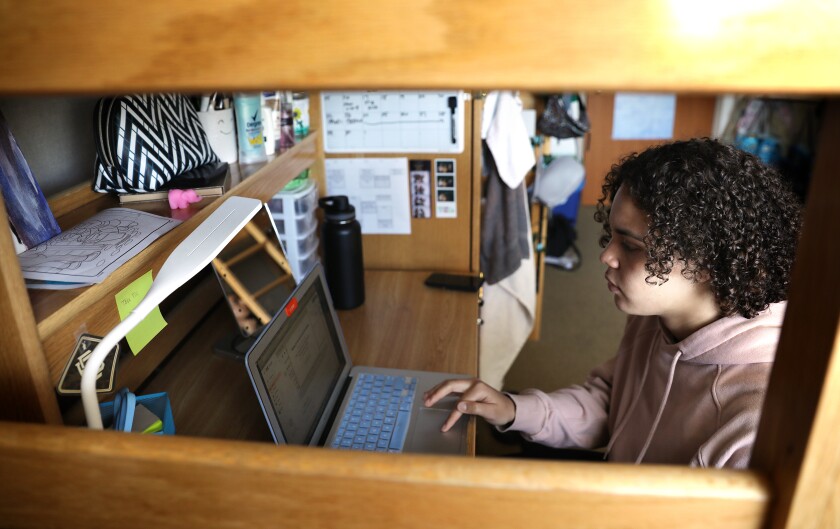 UCLA student Kiera Laney, 20, attends a class online in her dorm room on campus. UC may reopen only one-third to one-half of dorms this fall. 