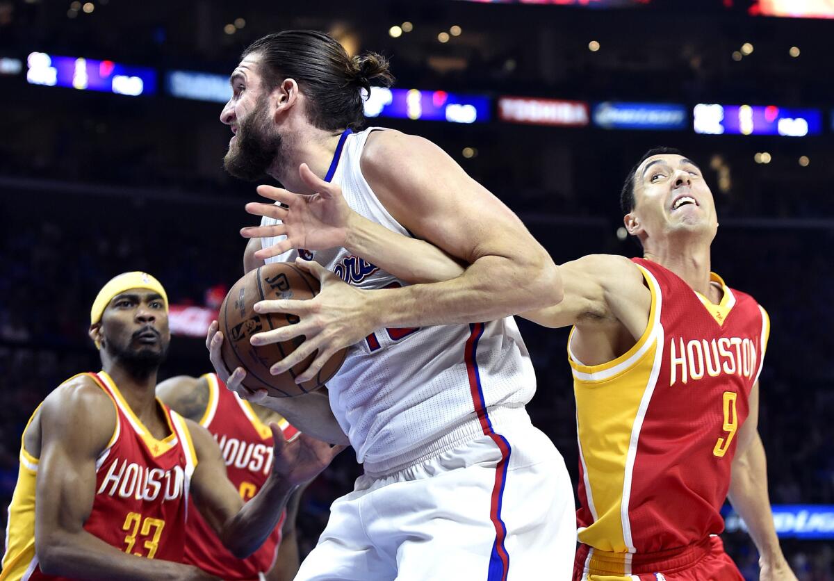 Spencer Hawes of the Clippers is fouled by Pablo Prigioni of the Rockets last season. Prigioni signed with the Clippers on Tuesday.