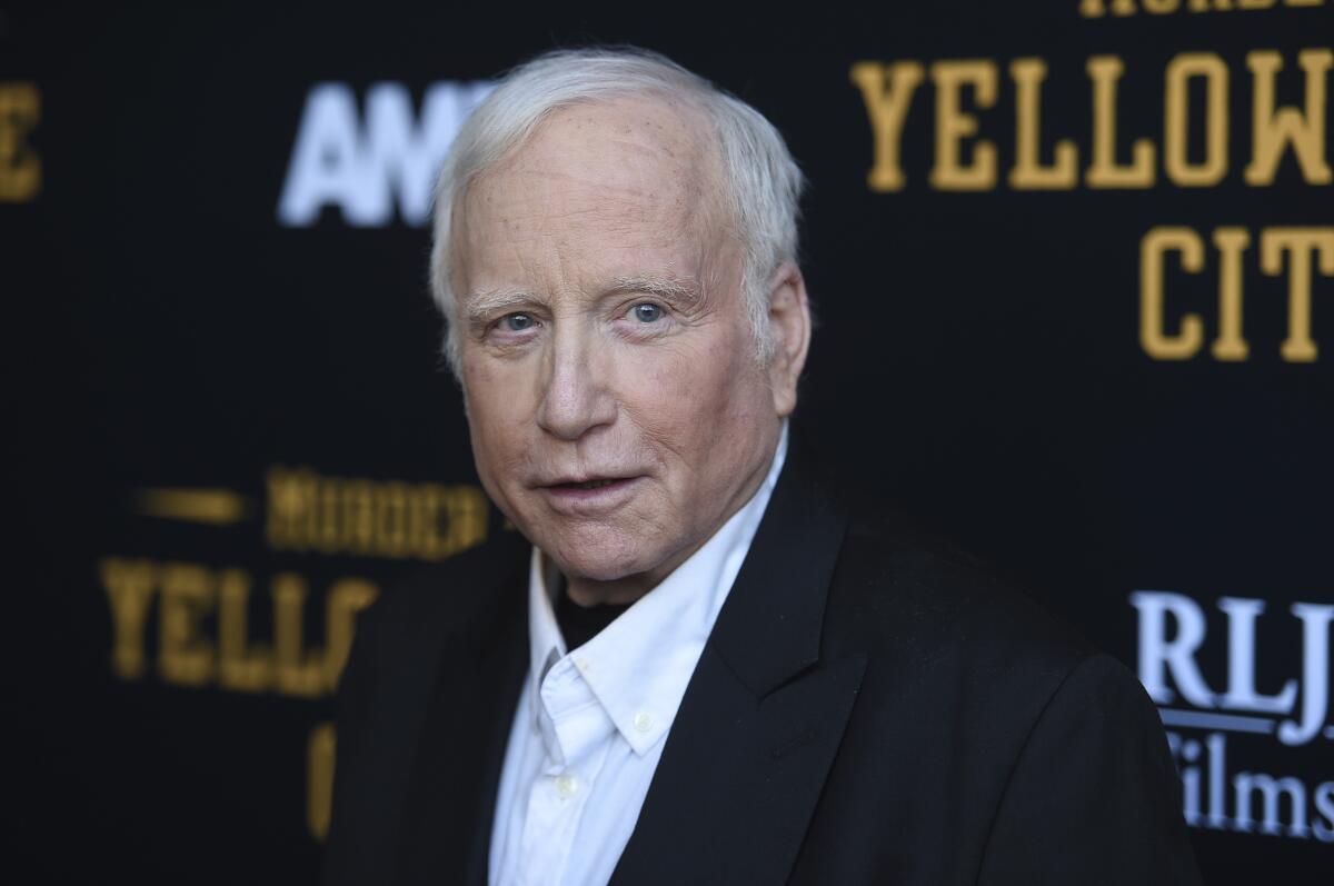 Richard Dreyfuss poses in a black suit jacket and white shirt