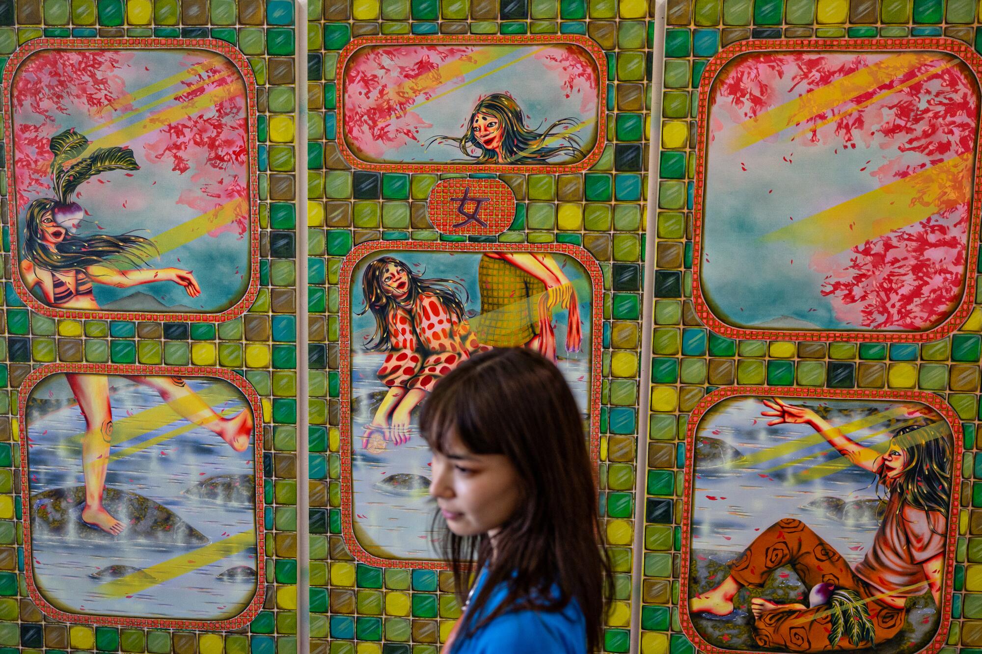Zoe Blue M. in front of one her paintings.