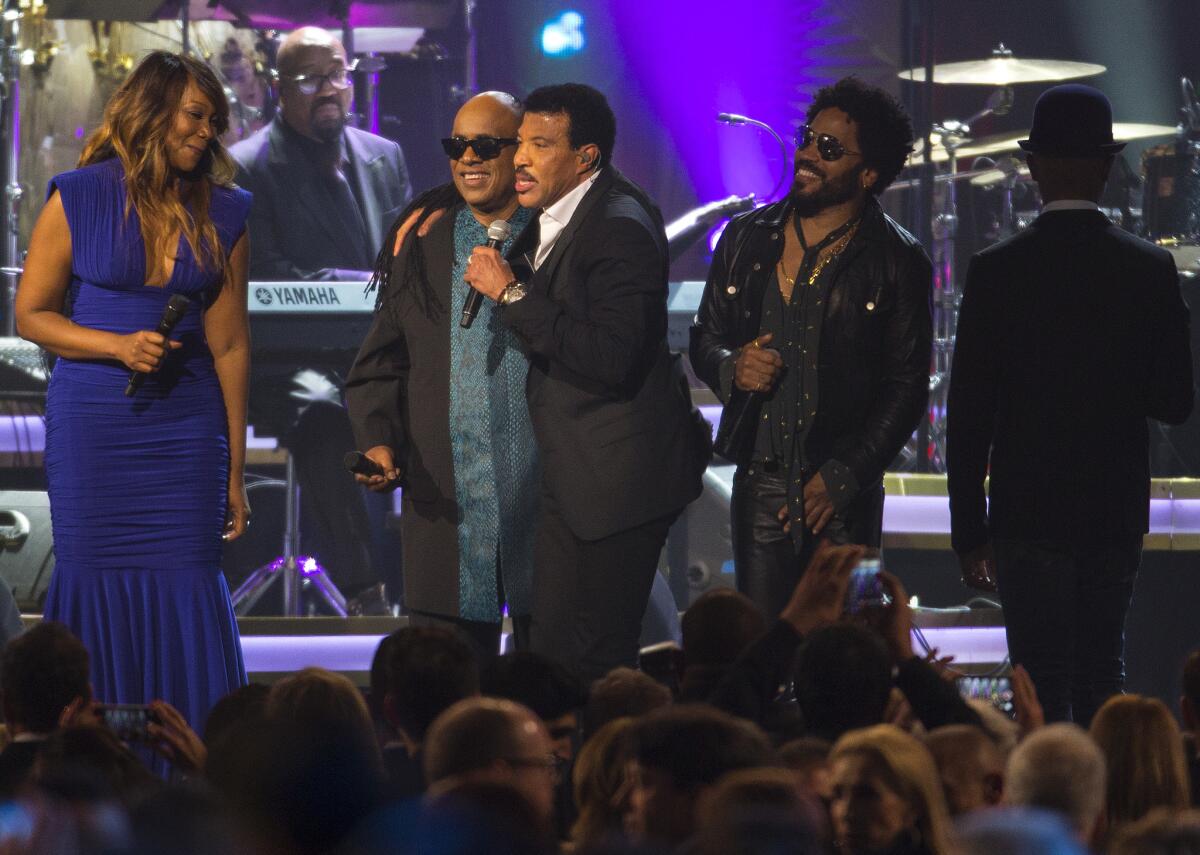 Lionel Richie sings with Yolanda Adams, Stevie Wonder, second from left, and Lenny Kravitz, right, Saturday night during the MusiCares Person of the Year gala in Los Angeles.