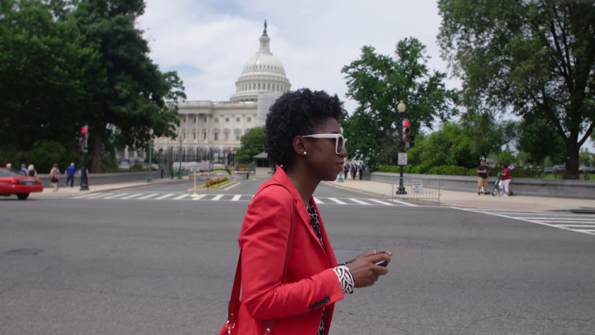 MIT researcher Joy Buolamwini walking in Washington, D.C., in the documentary "Coded Bias."