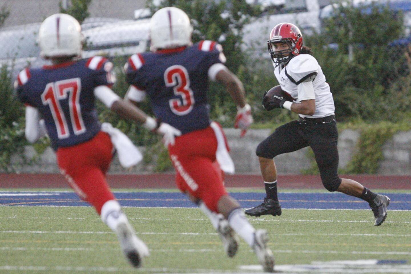 Glendale's Christian Osorio, right, runs with the ball during a game against La Salle at La Salle High School in Pasadena on Friday, on August 31, 2012.