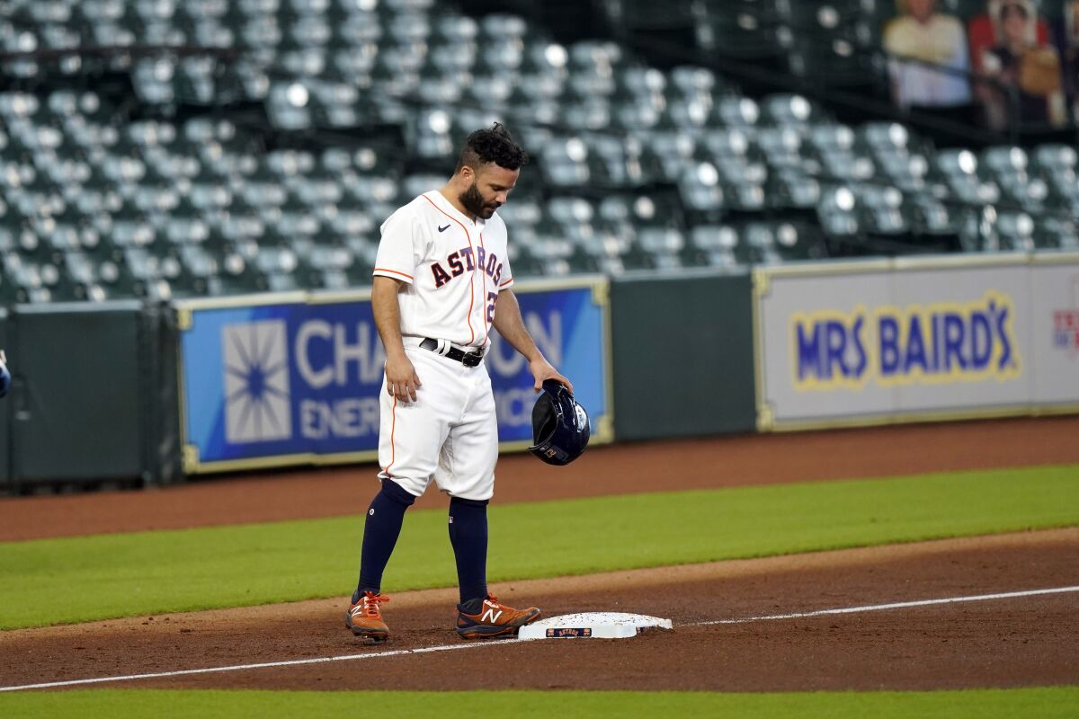 Houston Astros' Jose Altuve stands at third base after sliding safely while advancing from second to third during the first inning of a baseball game against the Texas Rangers Thursday, Sept. 3, 2020, in Houston. Altuve left the game after the second inning. (AP Photo/David J. Phillip)