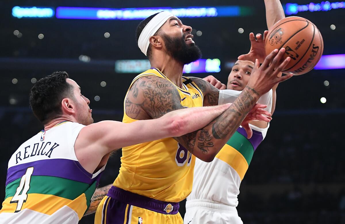Lakers forward Markieff Morris is fouled by Pelicans guard JJ Redick (4) as he drives to the basket during a game Feb.25, 2020, at Staples Center.