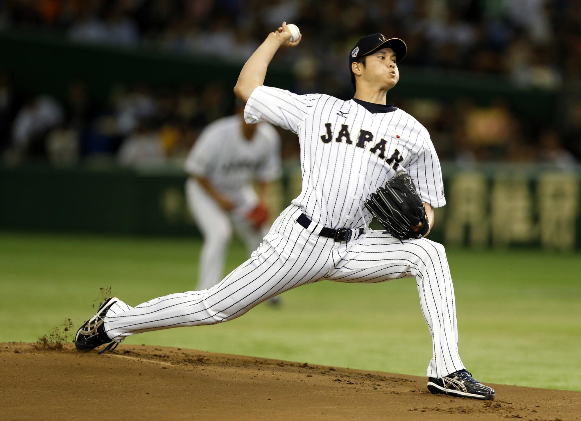 Japan starter Shohei Ohtani delivers against South Korea in a Premier12 world tournament game in November 2015.