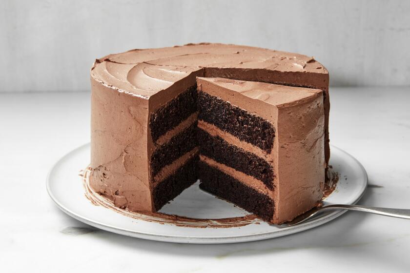 Chocolate layer cake, with a slice being taken out.