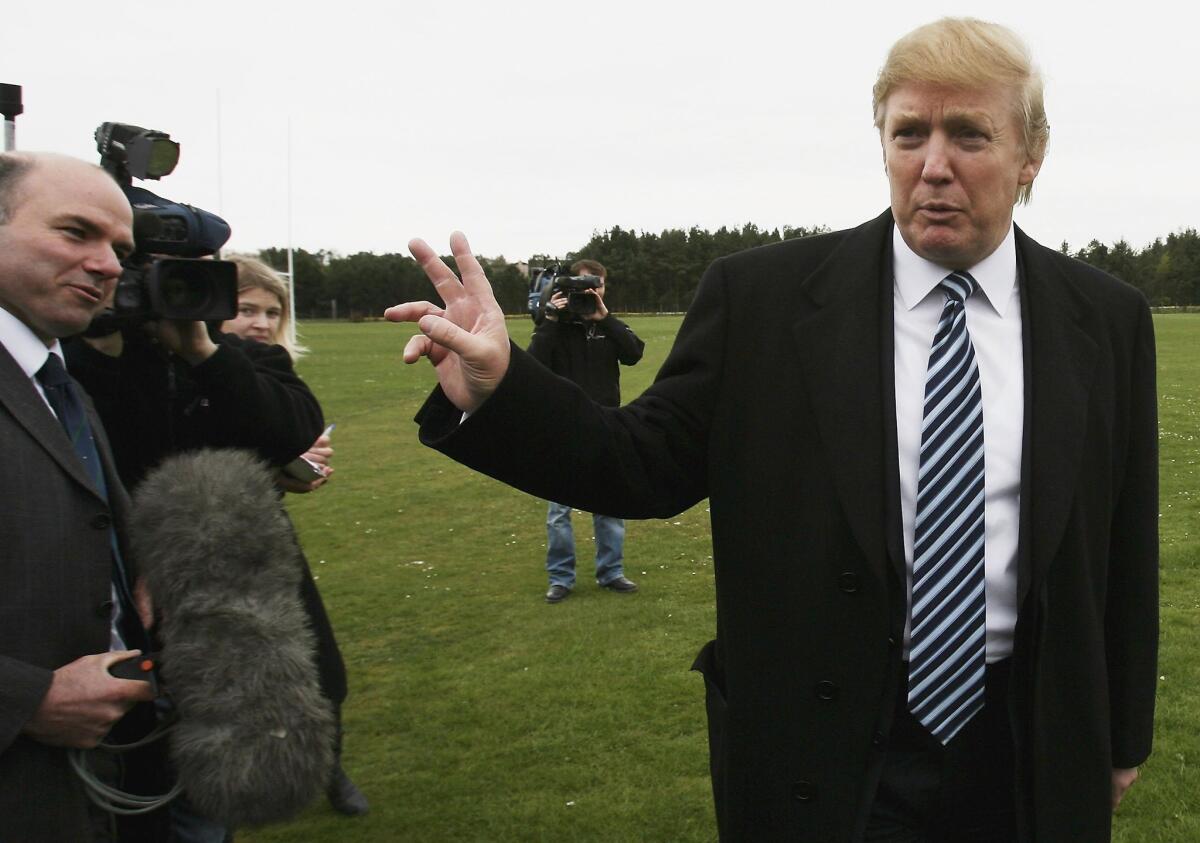Donald Trump arrives at the Old Course in St. Andrews, Scotland, where he was meeting with the media to answer questions regarding Trump International Golf Links in this April 28, 2006, file photo.
