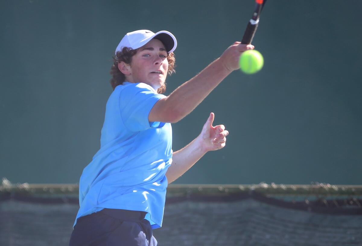 Corona del Mar's Roger Geng hits a forehand at No. 1 doubles against University on Wednesday at University High in Irvine.