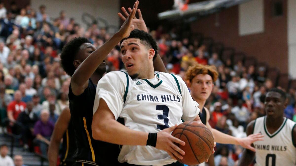 Chino Hills' LiAngelo Ball drives to the hoop against Birmingham's Devonaire Doutrive on March 10.