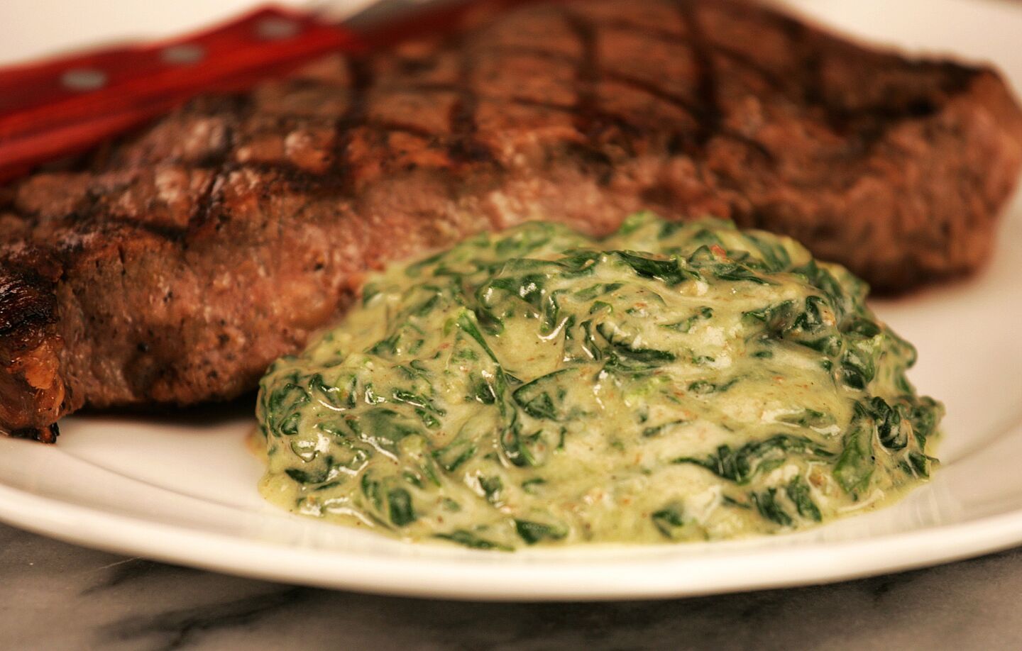 A reader asked the test kitchen for a creamed spinach recipe the way it's served at Morton's, Lawry's and other steak houses. "Don't go low-cal on me," he implored. The result: Recipe: Creamed spinach