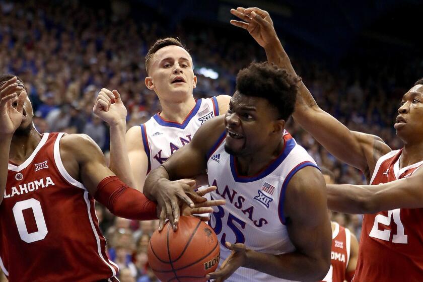 LAWRENCE, KANSAS - JANUARY 02: Udoka Azubuike #35 of the Kansas Jayhawks battles Christian James #0 and Kristian Doolittle #21 of the Oklahoma Sooners for a rebound during the game at Allen Fieldhouse on January 02, 2019 in Lawrence, Kansas. (Photo by Jamie Squire/Getty Images) ** OUTS - ELSENT, FPG, CM - OUTS * NM, PH, VA if sourced by CT, LA or MoD **