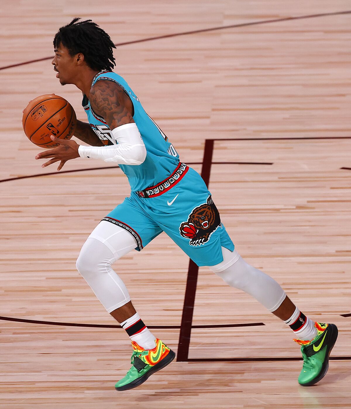 Ja Morant of the Memphis Grizzlies' dribbles the ball down court during the first half of an NBA basketball game Sunday, Aug. 9, 2020, in Lake Buena Vista, Fla. (Kevin C. Cox/Pool Photo via AP)