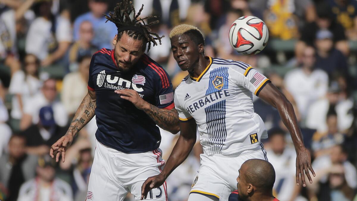 The Galaxy's Gyasi Zardes, right, competes with New England midfielder Jermaine Jones for the ball during the MLS Cup championship game on Dec. 7. The Galaxy opens the 2015 MLS season on March 6 hosting the Chicago Fire.